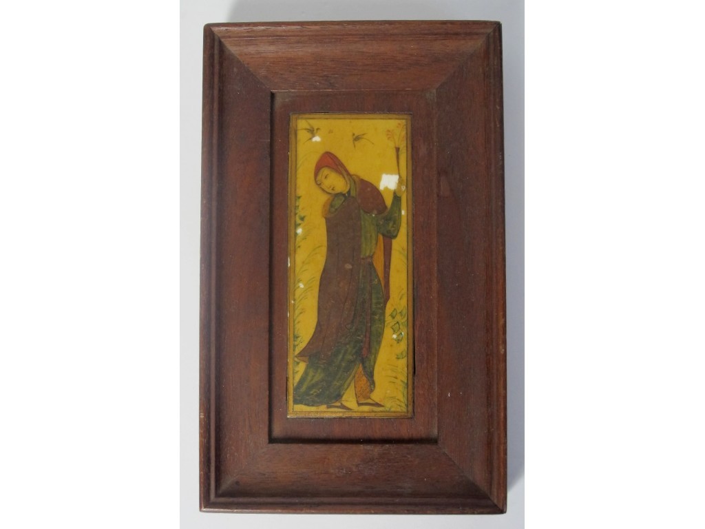 Appraisal: A Persian painted ivory plaque of a robed woman holding