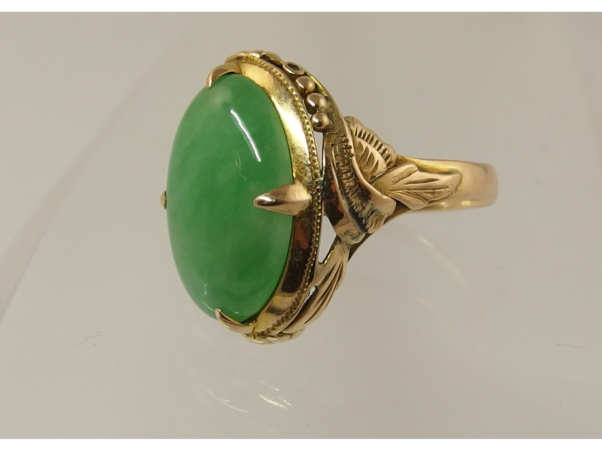 Appraisal: A yellow metal Chinese green hardstone ring