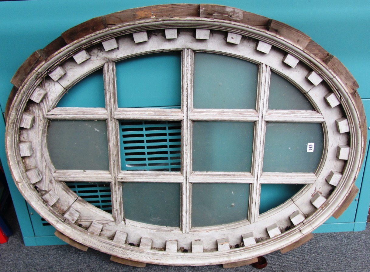 Appraisal: A white painted pine oval window with twelve panels cm