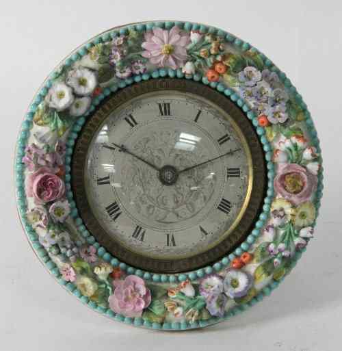 Appraisal: A porcelain mounted easel clock of circular form with flower