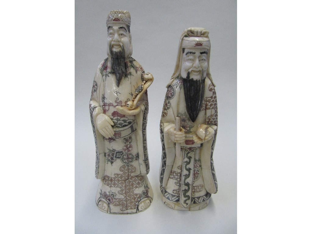 Appraisal: Pair of carved and stained bone figures of scholars