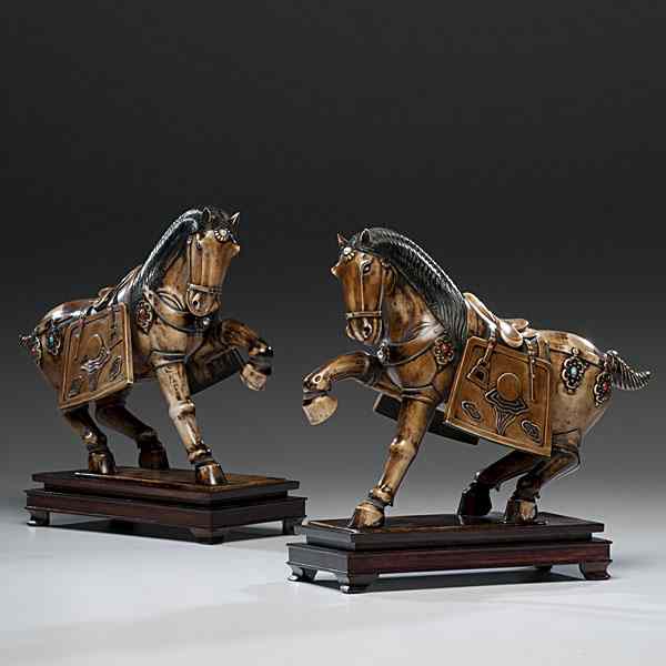 Appraisal: Chinese Ivory Horses Chinese A pair of stained Tang-style carved