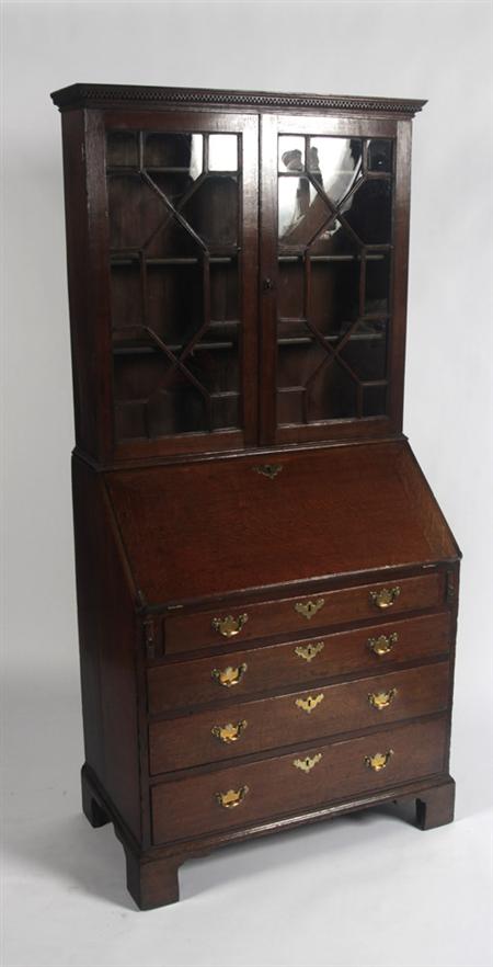 Appraisal: A late th century oak bureau bookcase the projected moulded