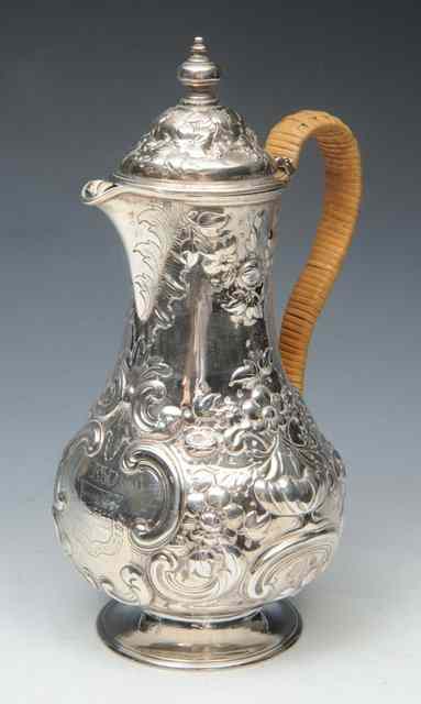 Appraisal: A SILVER CHOCOLATE POT of baluster form with embossed floral