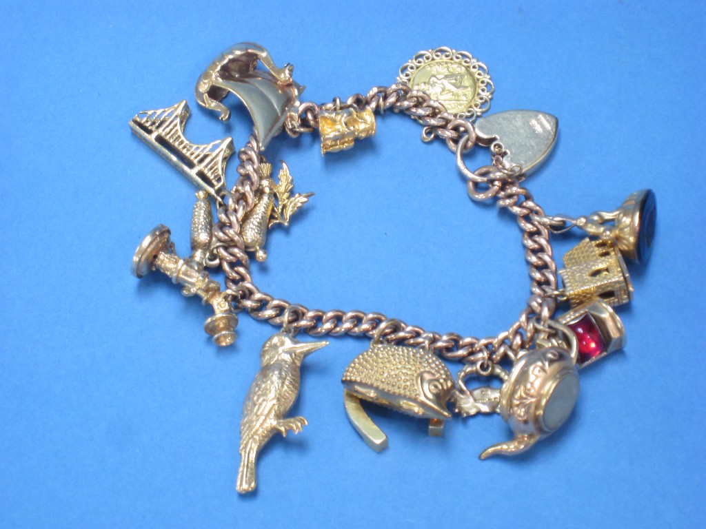 Appraisal: A ct gold Charm Bracelet with fourteen charms including yacht