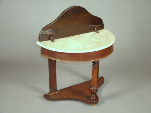 Appraisal: A Victorian mahogany demi-lune washstand the raised back above variegated