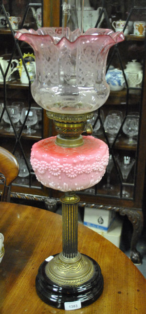 Appraisal: A Victorian brass reeded-column oil lamp with pink glass reservoir