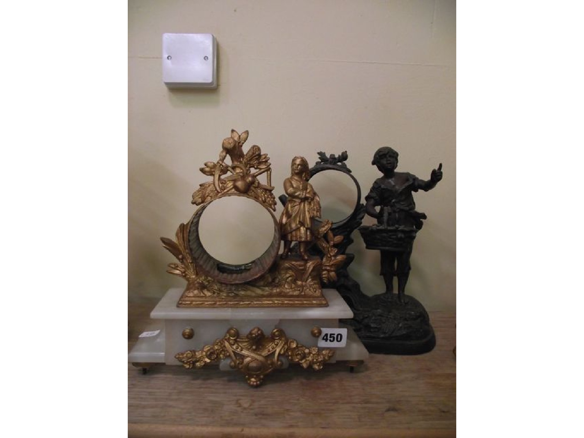 Appraisal: Two th century spelter clock cases with character mounts