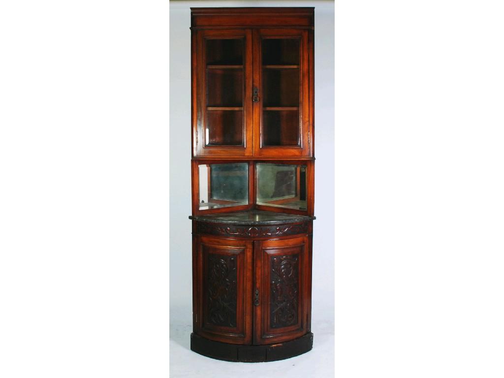 Appraisal: LATE VICTORIAN CARVED WALNUTWOOD DOUBLE CORNER CUPBOARD the flat fronted