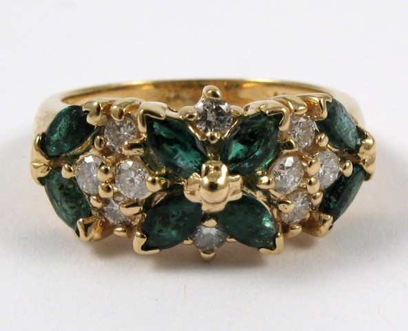 Appraisal: EMERALD AND FOURTEEN KARAT GOLD RING set with eight marquise-cut