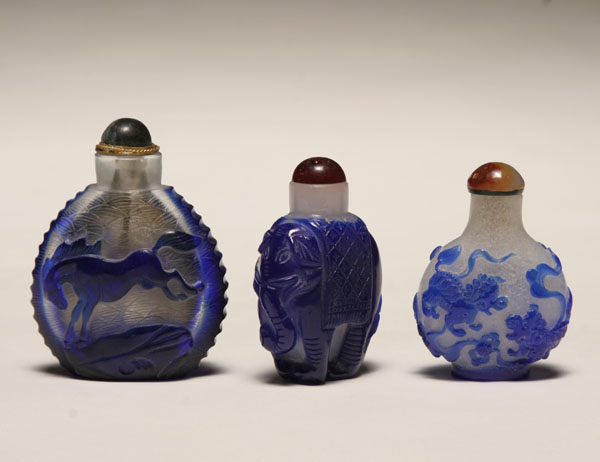 Appraisal: Three Chinese Peking glass snuff bottles with blue overlay all