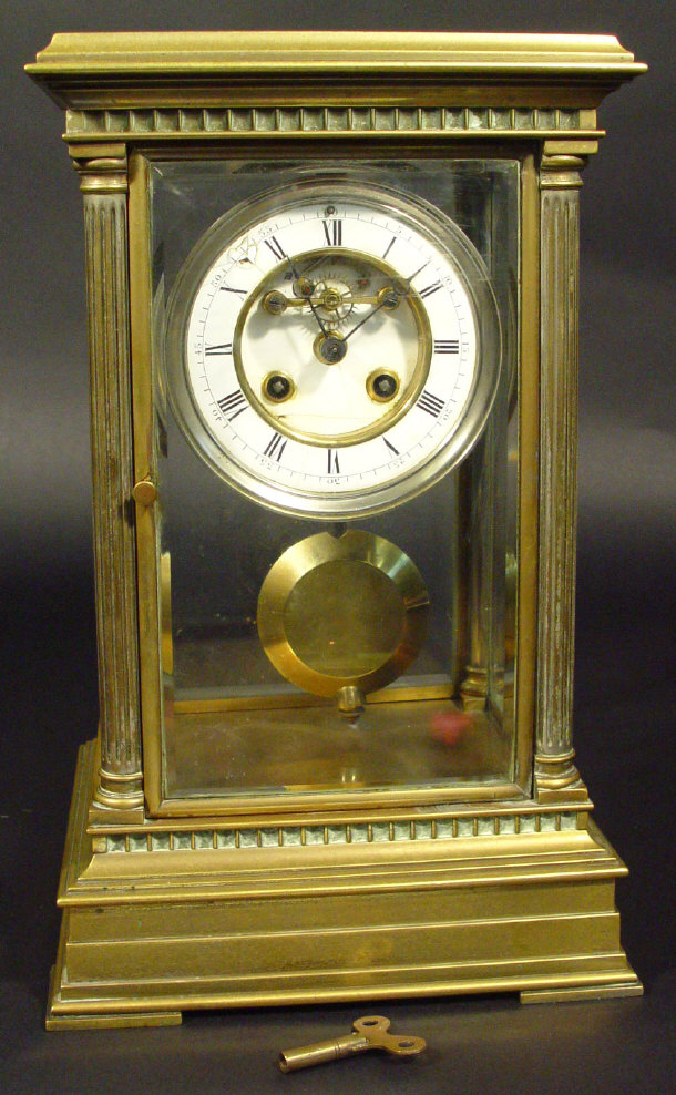 Appraisal: Brass four pillar mantel clock the bevelled glass panels supported