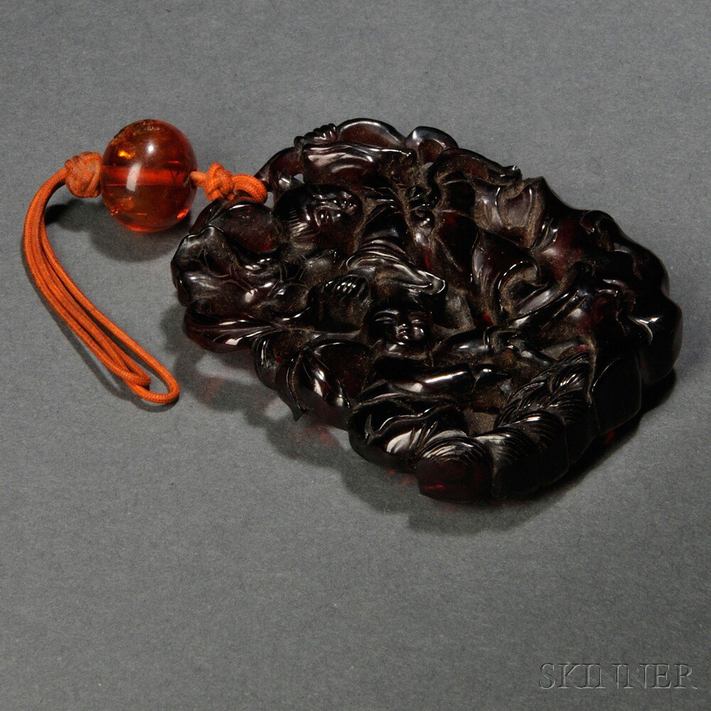 Appraisal: Openwork Amber Pendant China rounded rectangular form carved and pierced