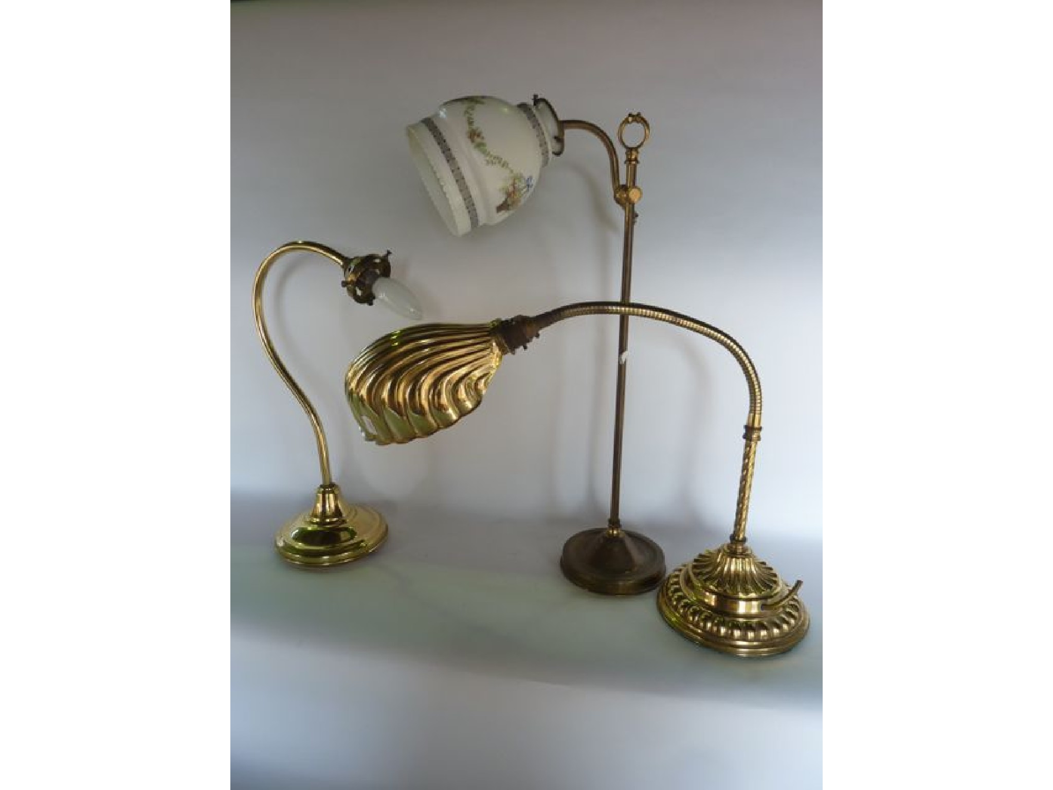 Appraisal: A brass electronic desk lamp with reticulated stem and fluted