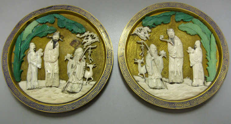 Appraisal: PAIR OF CHINESE CARVED IVORY PLAQUES Each circular depicting three