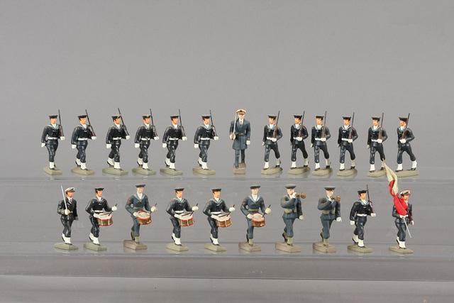 Appraisal: Lot of plastic composition type figures marching Includes officer flag