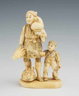 Appraisal: A Carved Ivory Figural Group Depicting a man holding a