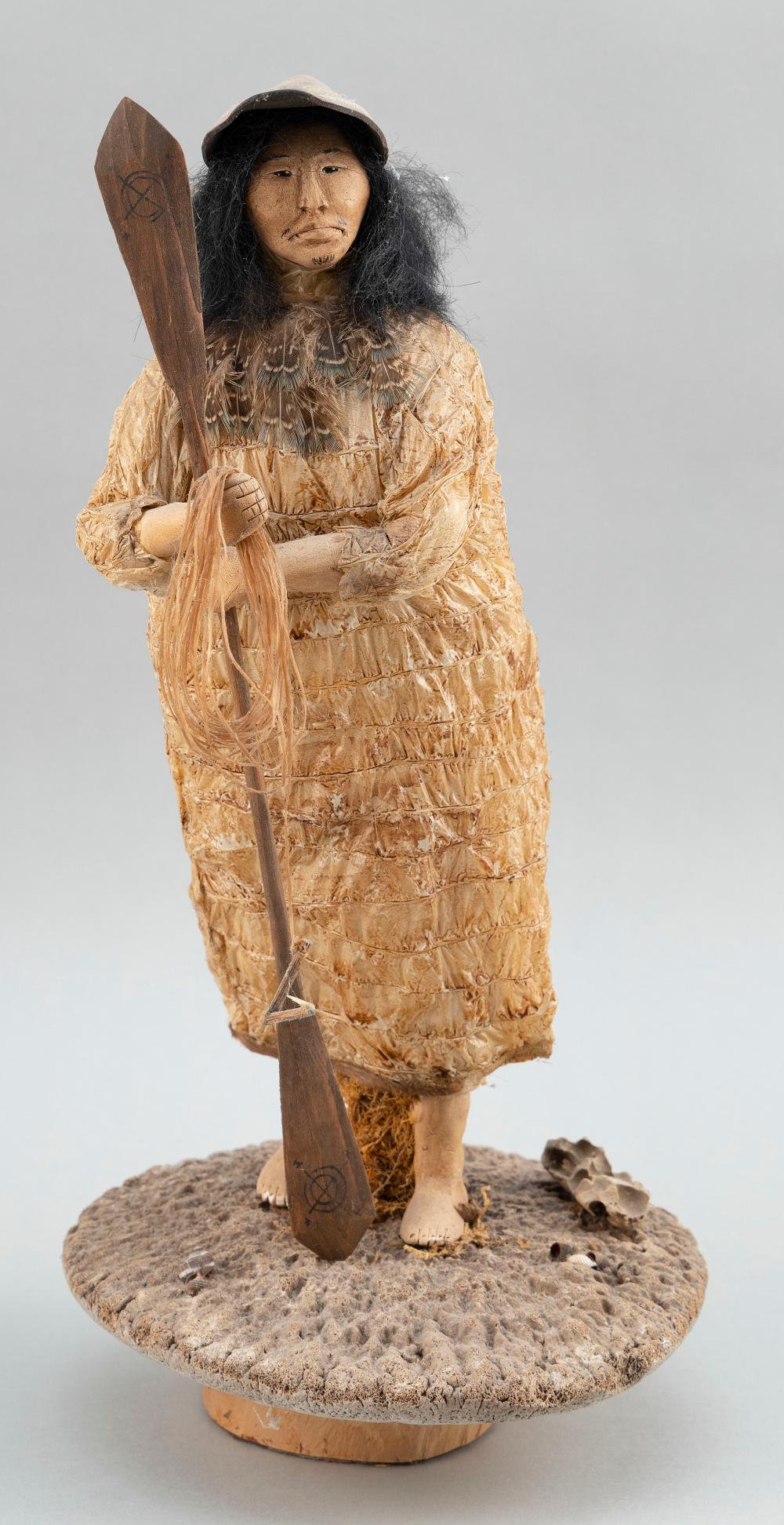 Appraisal: FIGURE OF AN INUIT HOLDING A KAYAK PADDLE TH CENTURY