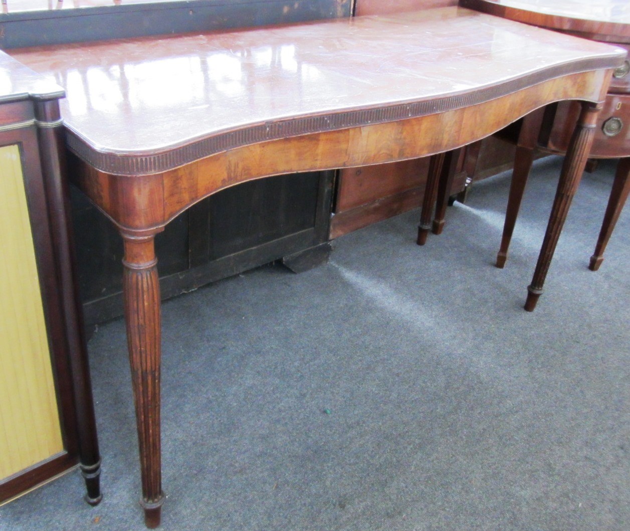 Appraisal: A th century mahogany serving table the serpentine top on