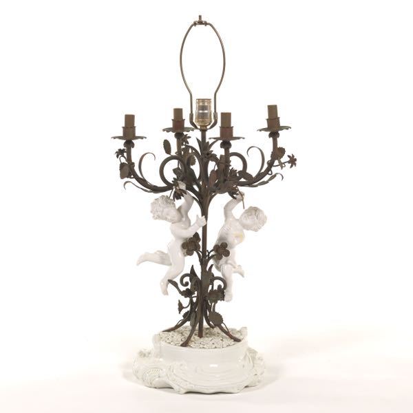 Appraisal: CANDELABRA TABLE LAMP WITH PORCELAIN CHERUBS x Electrified metal candelabra