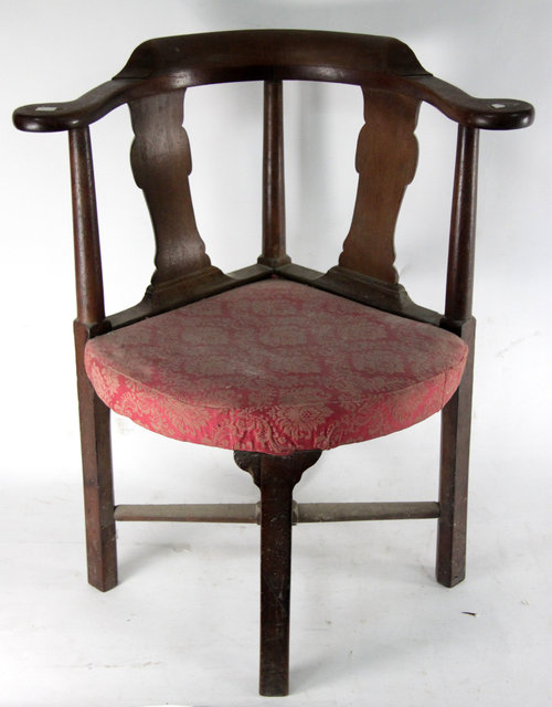 Appraisal: A George II walnut corner chair with shaped cresting rail