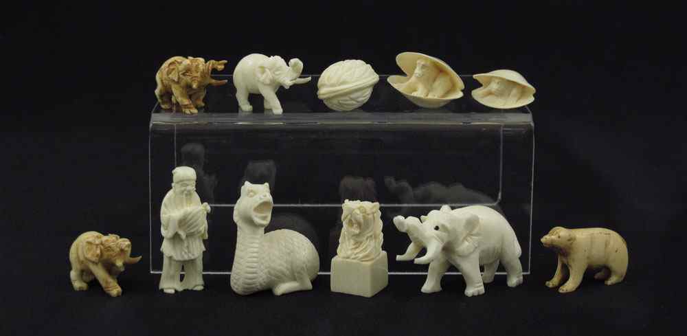 Appraisal: MINIATURE IVORY NETSUKE OKIMONO To Netsuke to include Man holding