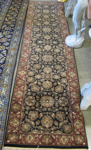 Appraisal: HAND KNOTTED ORIENTAL RUNNER Indo-Persian overall floral design on black