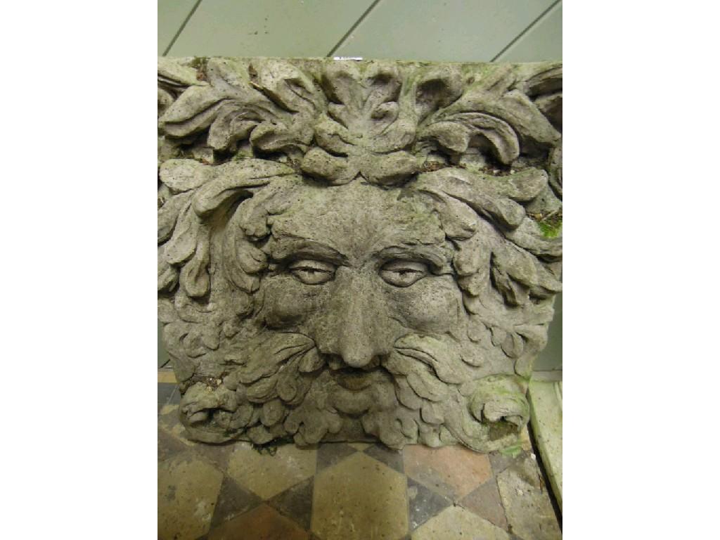 Appraisal: A large weathered composition stone green man wall mounted plaque