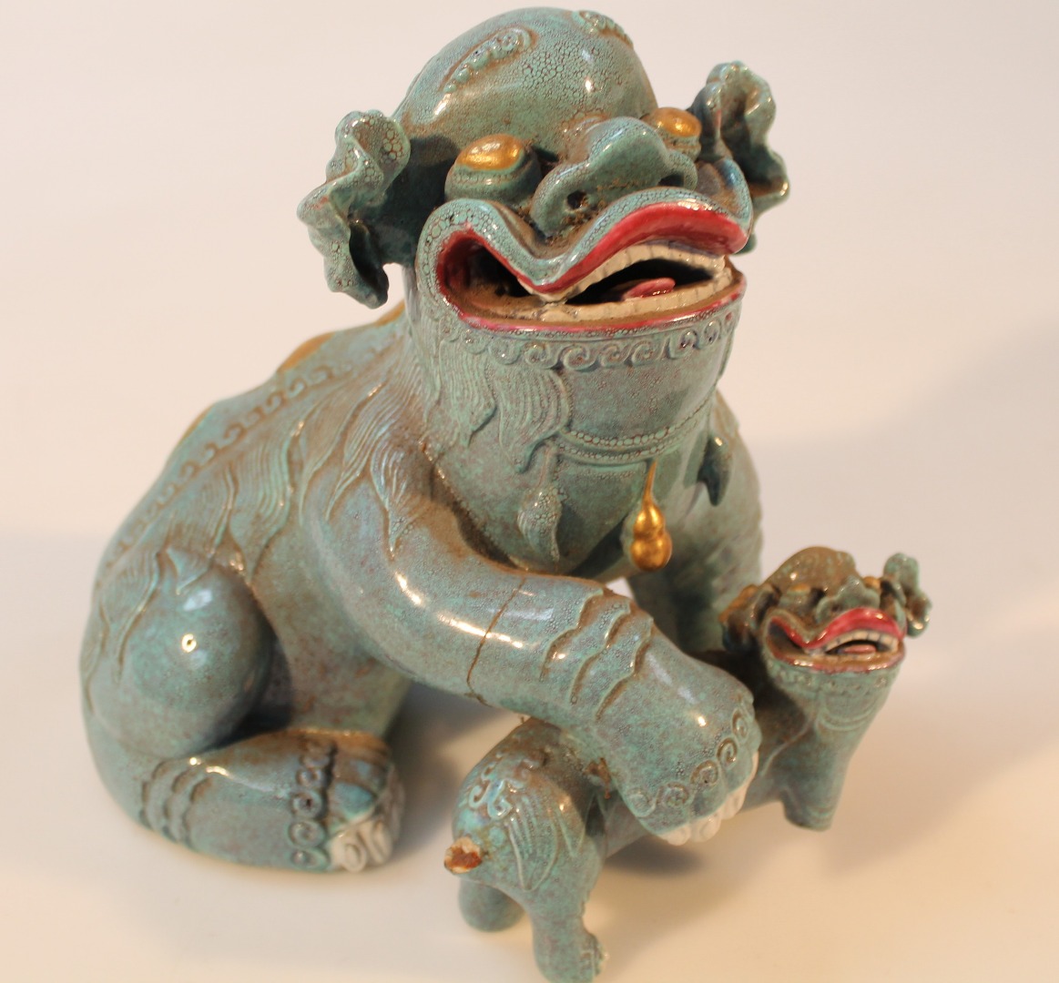 Appraisal: A Chinese figure group of a dragon and young predominately