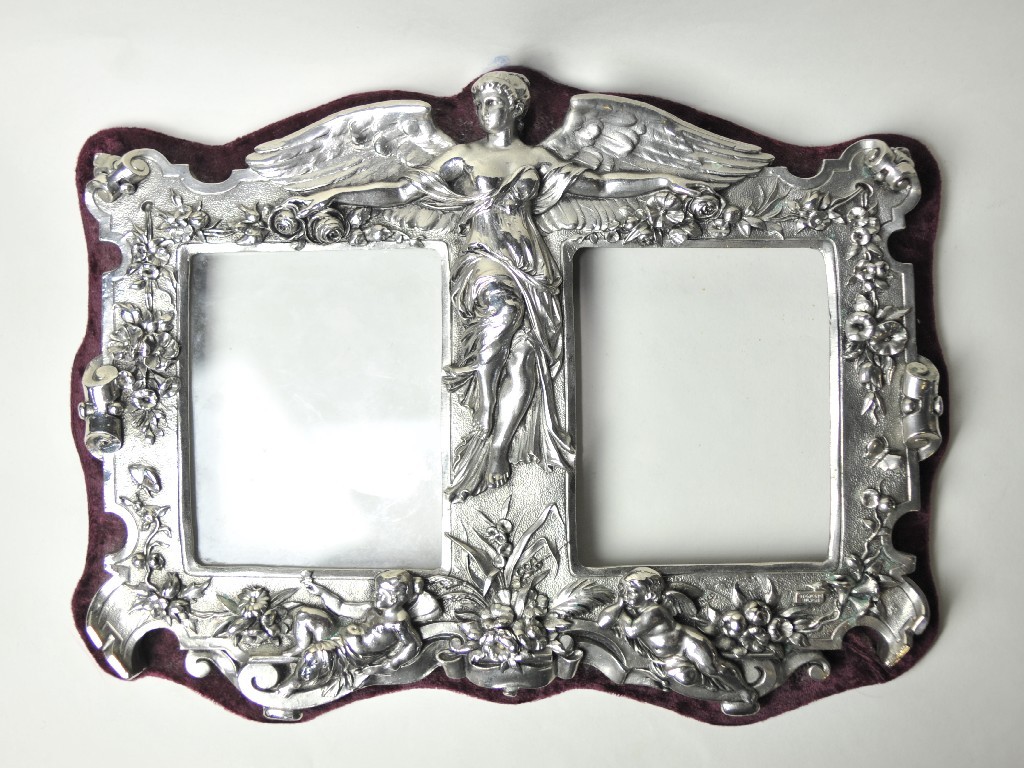 Appraisal: Sterling silver duet photo frame decorated with figures and flowers