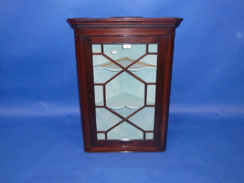 Appraisal: A Georgian style mahogany hanging corner cupboard with astragal glazed