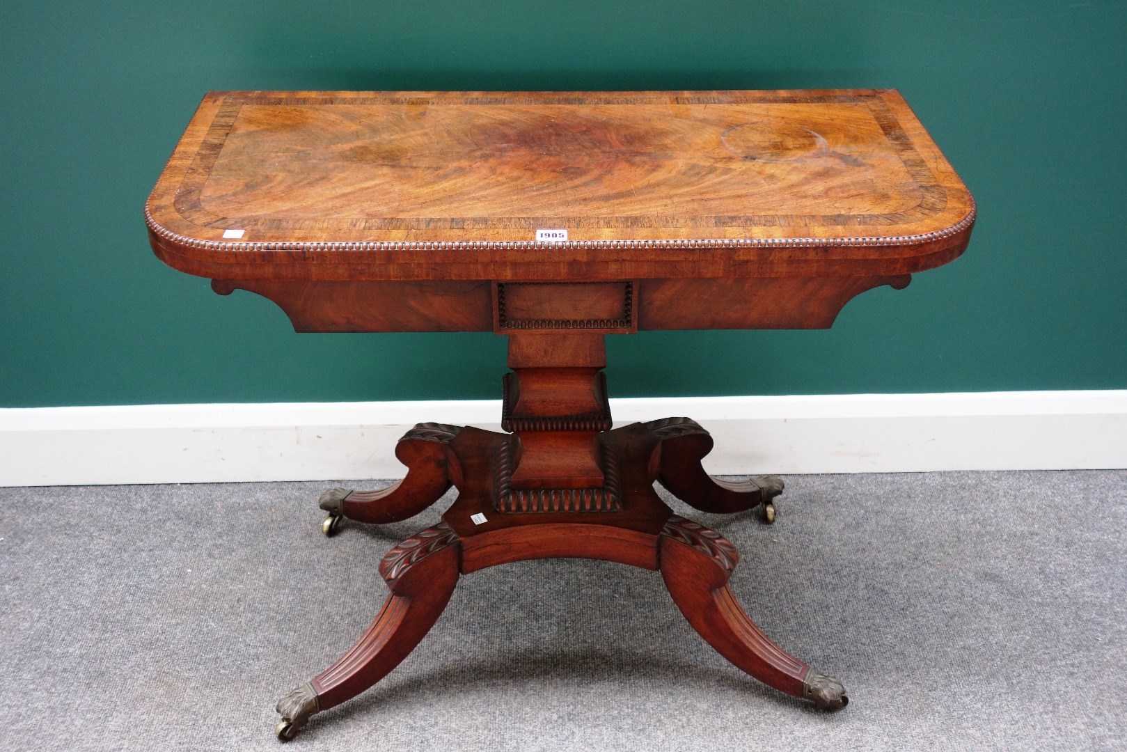 Appraisal: A George III rosewood banded mahogany card table on shaped