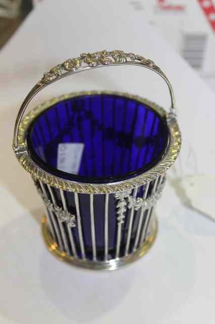 Appraisal: A SILVER SALT of basket form with blue glass liner