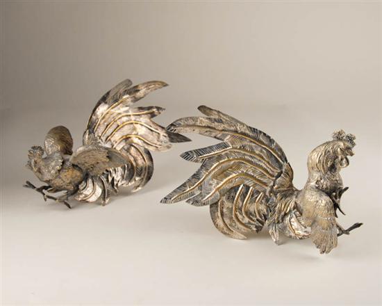 Appraisal: A Pair of Silver over Brass Fighting Cocks high