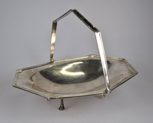 Appraisal: A fruit basket of elongated octagonal form with swing handle