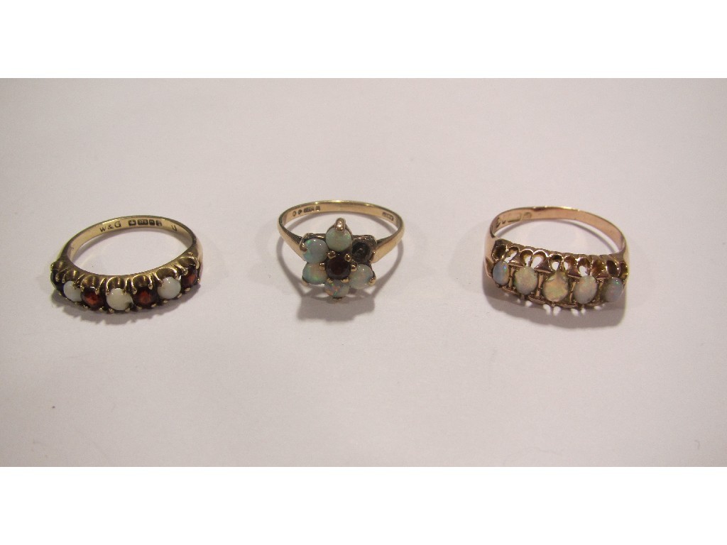 Appraisal: Three ct gold rings with opals and garnets