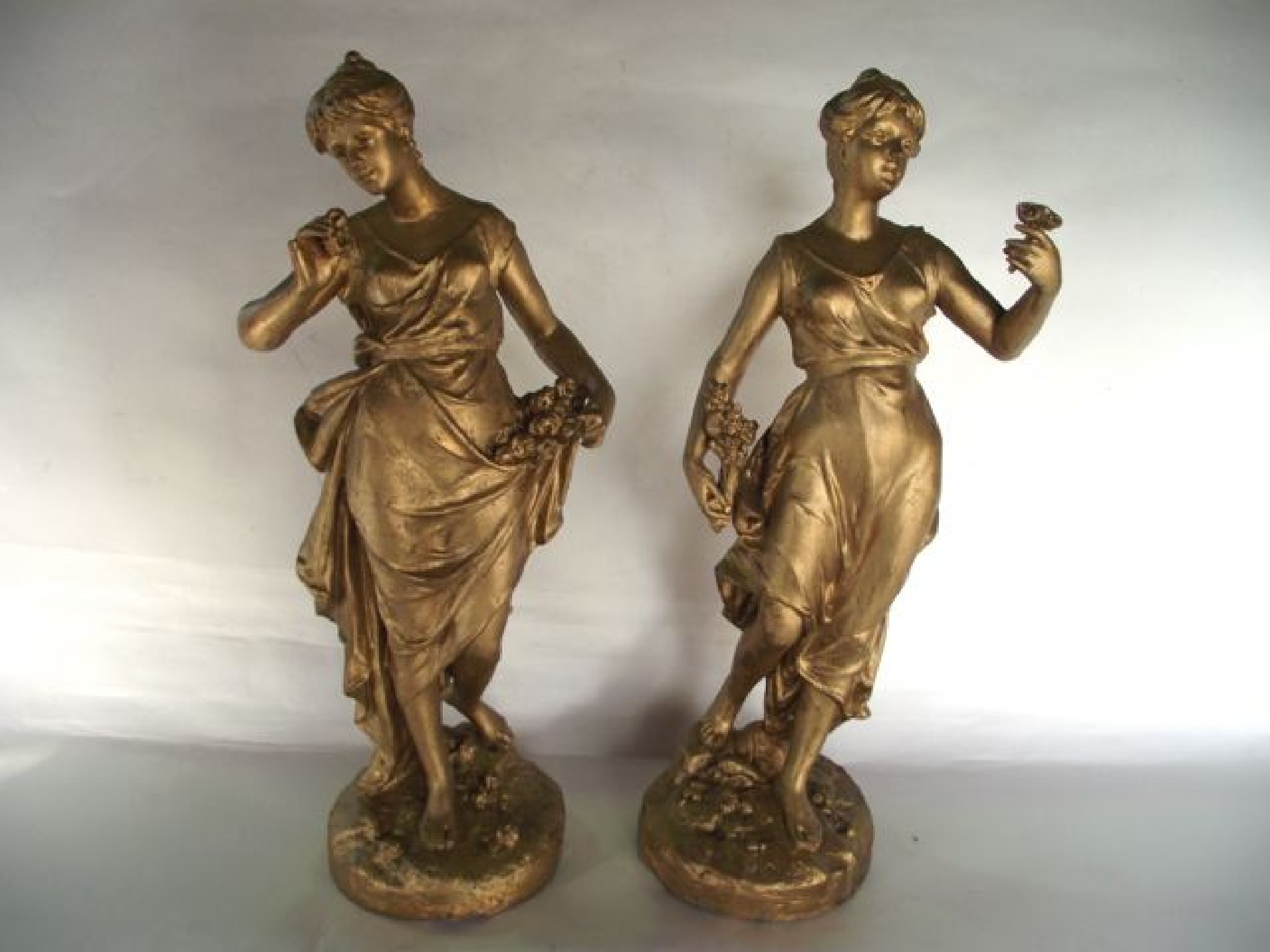 Appraisal: A pair of gilded composition figures of standing classical females