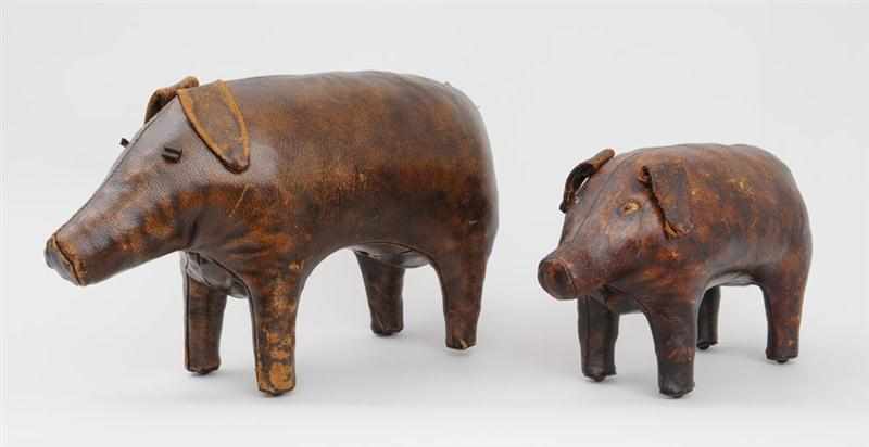 Appraisal: TWO GRADUATED STITCHED LEATHER-CLAD PIG-FORM FOOT STOOLS x in and