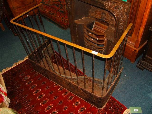 Appraisal: A Victorian black painted iron and brass railed nursery fender