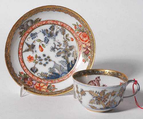 Appraisal: HAUSMALER DECORATED CUP AND SAUCER Meissen circa With underglaze blue