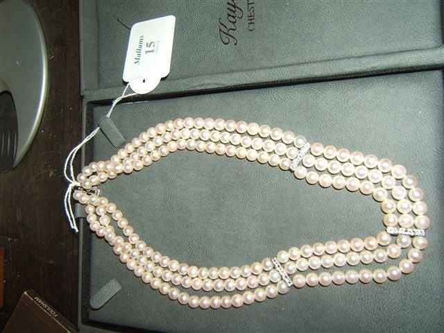 Appraisal: A three strand pearl necklace with ct white gold and