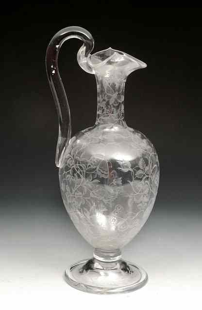 Appraisal: A GLASS CLARET JUG with scroll handle and acid etched