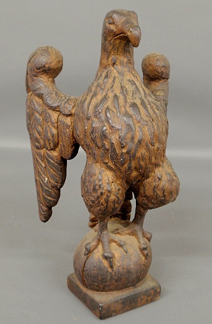 Appraisal: - Faux wood carved plaster eagle standing on an orb