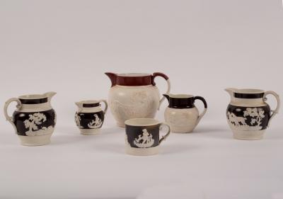 Appraisal: Four th Century jugs with raised decoration of hunting scenes