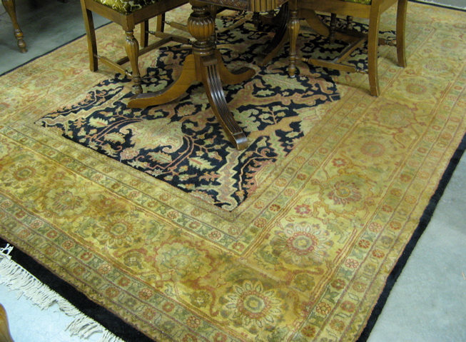 Appraisal: HAND KNOTTED ORIENTAL CARPET Indo-Persian floral design on rectangular black