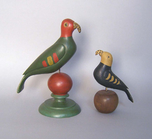 Appraisal: Two carved and painted parrots in the manner of Simmons