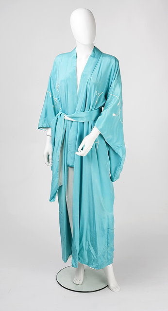 Appraisal: A turquoise blue silk robe embroidered with stylized Oriental foliage