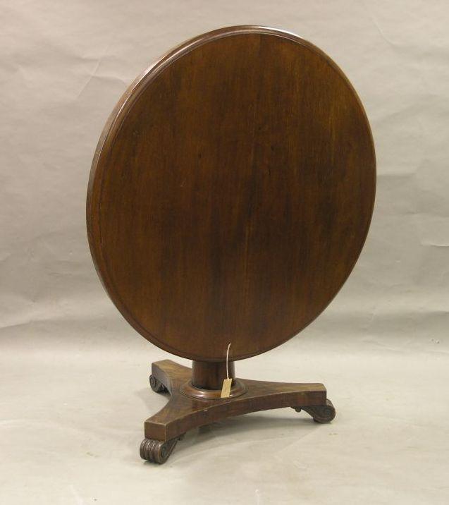 Appraisal: A Victorian mahogany breakfast table circular top tilting on tapering