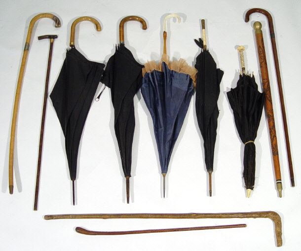 Appraisal: Collection of parasols and walking canes three with carved bone