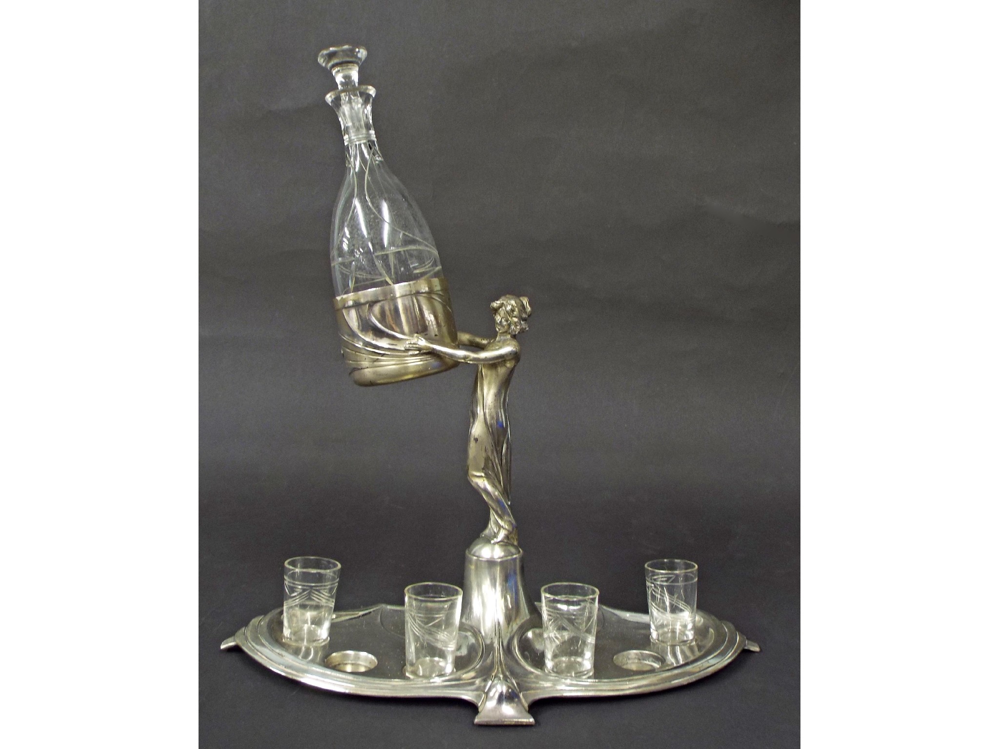 Appraisal: Good WMF polished pewter decanter set comprising a standing maiden